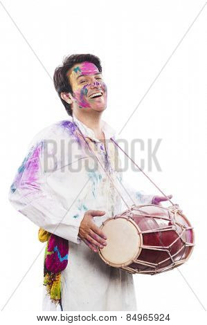 Man celebrating Holi with playing dholak