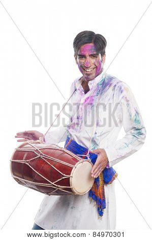 Man celebrating Holi with playing dholak