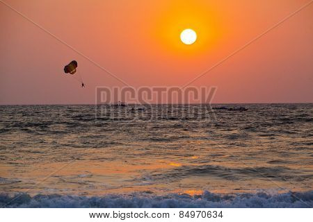 Silhouette of a person parasailing over the sea, Panjim, Goa, India