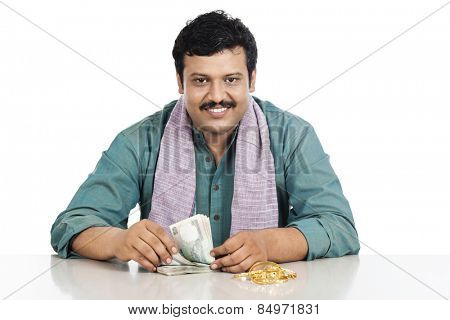 Portrait of a man counting money and smiling