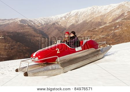Elderly couple on a pedalo in the snow