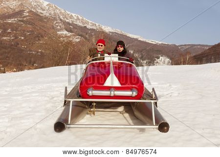 Elderly couple on a pedalo in the snow