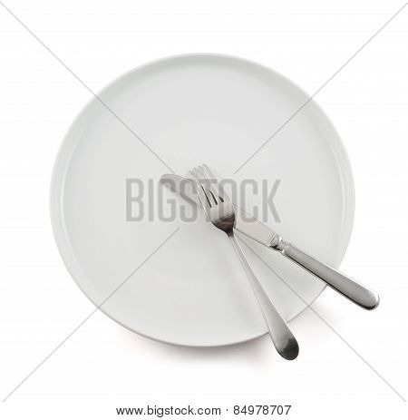 Table knife, fork and ceramic plate isolated