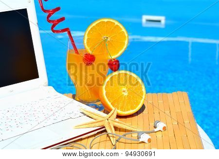 Cocktai With Fruits, Laptop And Starfish On Pool