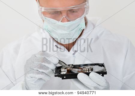 Man Repairing Harddisk With Tweezers