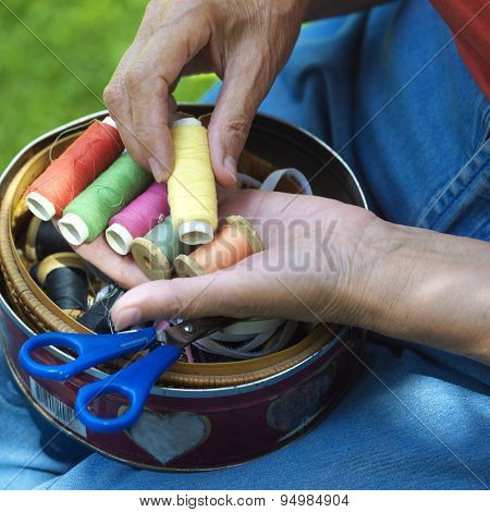 Hands With Spools Of Thread