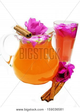 rose tea punch cocktail in jug and cup with cinnamon