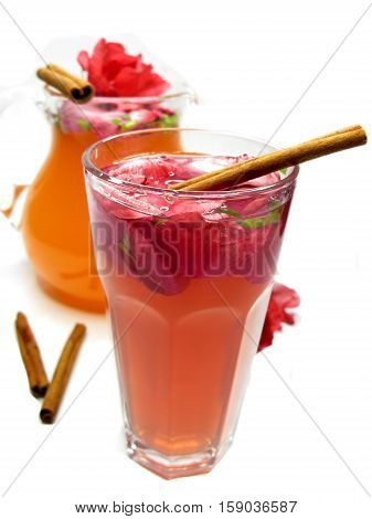 rose tea punch cocktail in jug and cup with cinnamon