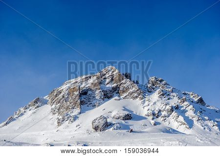 Alpine winter mountain landscape. French Alps covered with snow in sunny day. Val-d'Isere, France