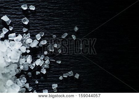 Coarse salt on a black background. Sea salt