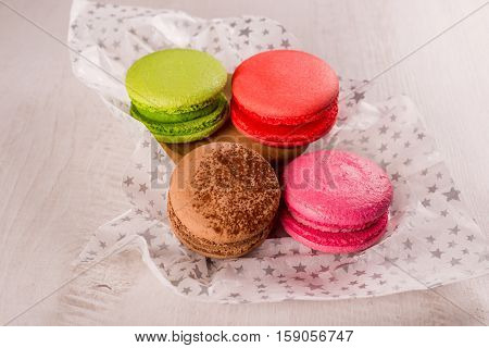Four different colors makarons on the table closeup shot