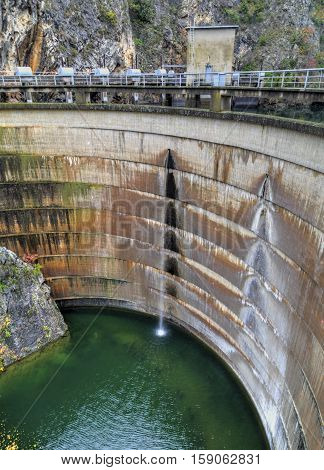 Water falls from the dam of hydroelectric power plant