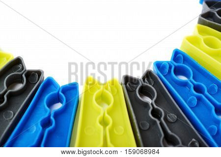 Semicirle shape of plastic cloth pegs isolated over white background