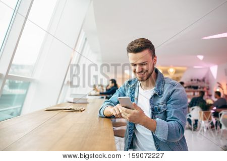 Guy Is Sitting In Front Of The Table Near Window