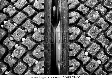 Close up of rocks stuck in industrial size truck tire treads