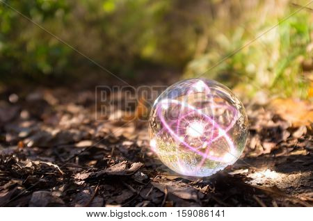 Magic crystal ball atom on forest floor for autumn fantasy imagery