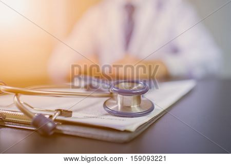 Medicine doctor's working table. Focus on stethoscope black and white. Technology doctor. Doctor hand. Doctor man. Tool doctor. Doctor room. Doctor clinic.