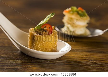 Polenta Cups With Shredded Ragu And Cabbage Chips In A Spoon. Taste Gastronomy Finger Food