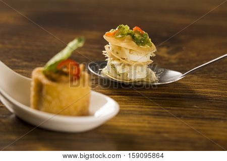 Thousand Leaves Stuffed With Cod Vinaigrette And Heart Of Palm In A Spoon. Taste Gastronomy Finger F