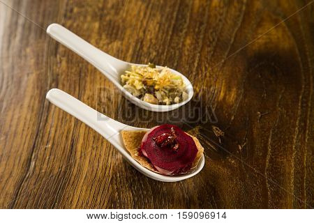 Thousand Leaves Of Radish And Beet With Caramelized Bacon Julienne In A Spoon. Taste Gastronomy Fing
