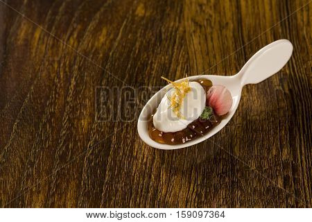 Natural Flavored Mint Yogurt, Pepper Sago Finished With Caramel In A Spoon. Taste Gastronomy Finger