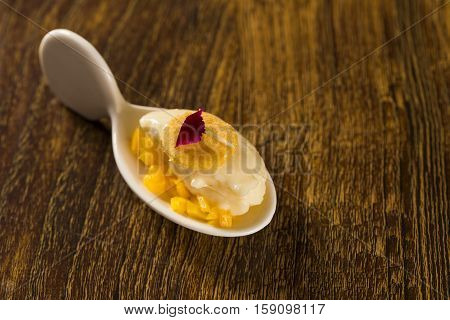 Baru Ice Cream With Chopped Mango And Cornmeal In A Spoon. Taste Gastronomy Finger Food