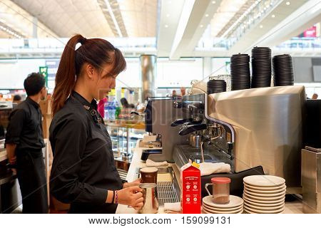 HONG KONG - CIRCA NOVEMBER, 2016: barista prepare coffee at a McCafe in Hong Kong. McCafe is a coffee-house-style food and drink chain, owned by McDonald's.