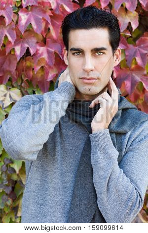 Handsome Man Wearing Winter Clothes In Autumn Leaves Background