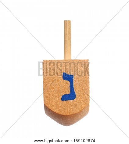 Wooden dreidel for Hanukkah on white background