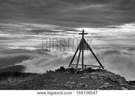 Wooden monument in Gerlitzen Apls Austria. Inverse weather.