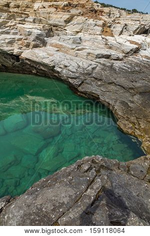 Green waters of Giola Natural Pool in Thassos island, East Macedonia and Thrace, Greece