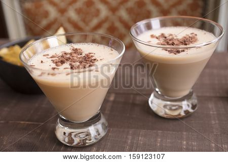 Two glasses filled with a milk amaretto hazelnut liqueur drink for a holiday get together