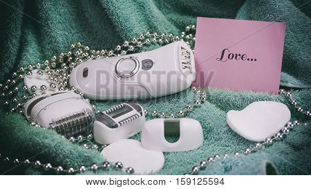 Epilatory With A Turquoise Background, Words On Pink Paper