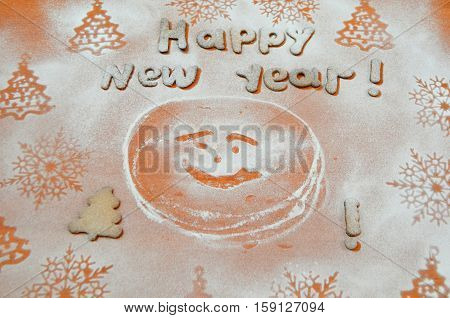 happy new year with a biscuit with icing sugar