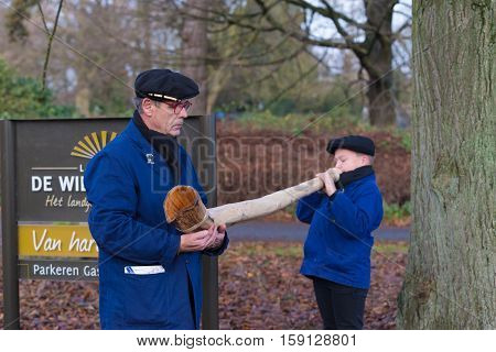 OLDENZAAL NETHERLANDS - NOVEMBER 27 2016: Unknown young boy blowing a so called 