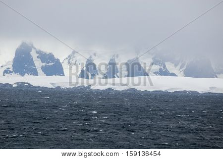 Antarctica in a cloudy day- Antarctic Peninsula - Palmer Archipelago - Neumayer Channel - Global warming - Fairytale landscape