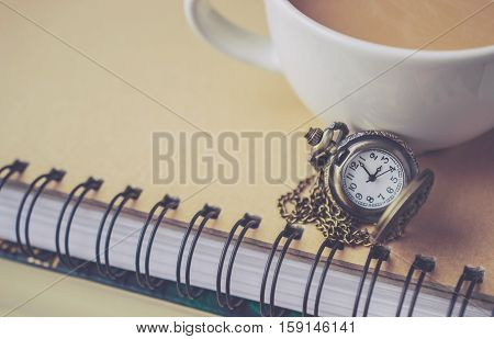 Pocket Watch on the Book and Coffee Cup with Blank Space in Vintage Tone