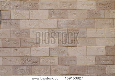 Texture of old white and beige brick wall surface with cement and concrete seams