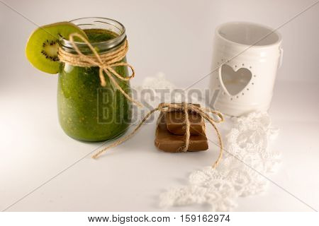 candle holder with heart smoothies lace and chocolate on a white backgraund