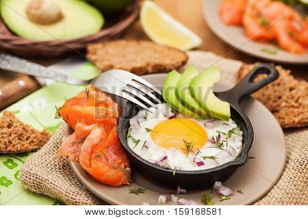 Fried Egg, Avocado And Smoked Salmon In Frying Pan