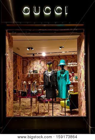 FLORENCE, ITALY - SEPTEMBER 21, 2016: Gucci luxury bags clothes and shoes sit displayed for sale inside a Gucci store.