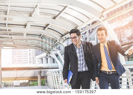 Two Businessman Dicussing Business In Central Of City. Concept Of Modern Business