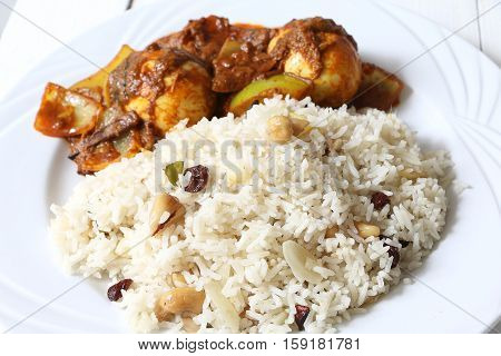 Anda or Egg curry served with roti/chapati/pualo/pilaf rice.