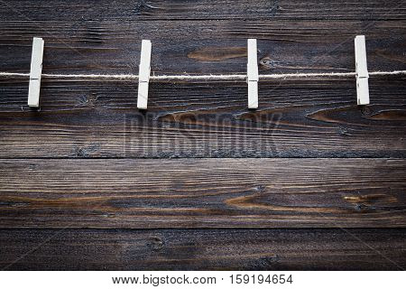 Wood Cloth Peg And Hemp Rope On Brown Plank Background