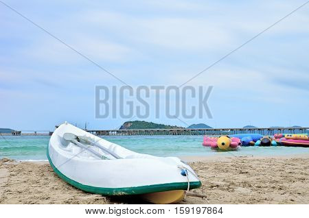 Canoes on the beach.A banana boat and bridge.