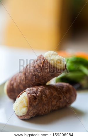 Two Tasty Cannoli on a Plate.