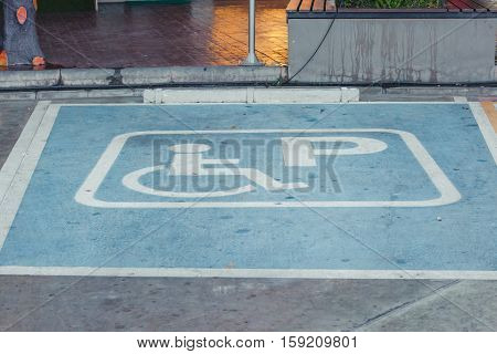 Symbol of the handicapped personDisabled parking sign in filling station Thailand.