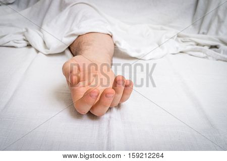 The Dead Man's Body Under White Cloth With Focus On Hand