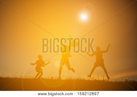 Silhouette of people playing guitar at the sky sunset happy time in holiday vintage tone