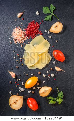 Top View Of Tasty Fresh Yellow Thin Slice Parm Cheese, Cuted Pear, Dry Pepper, Himalayan Salt, Tomat